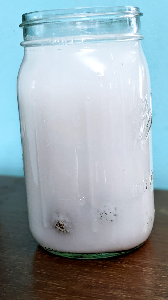 cloudy lime solution in glass jar